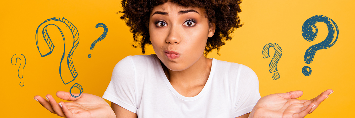 confused young woman with question marks in her hands