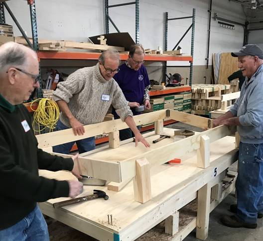 volunteers building a bed