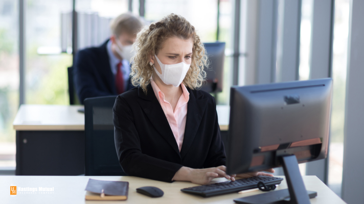 woman at desk with mask