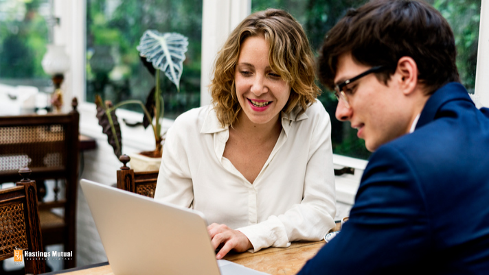 man and woman looking at a laptop screen