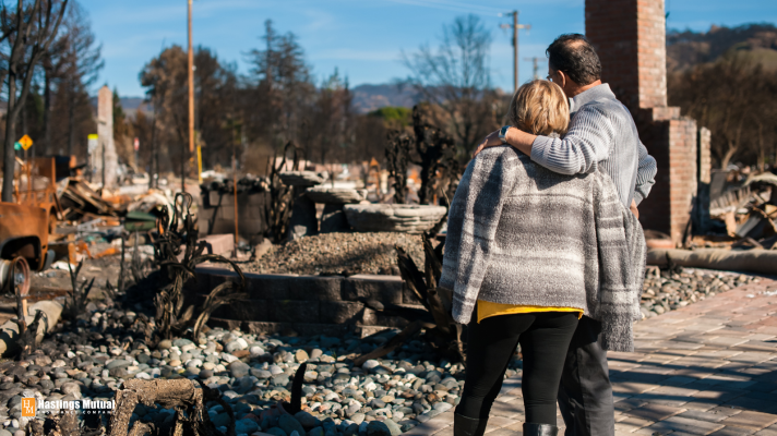 Destroyed House home owners looking at house damaged by fire