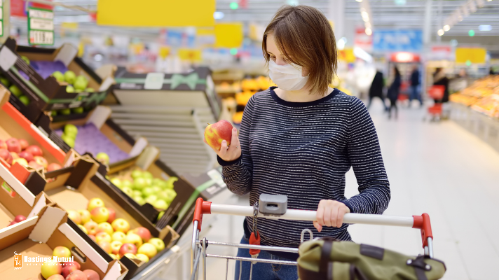 Woman grocery shopping in face mask