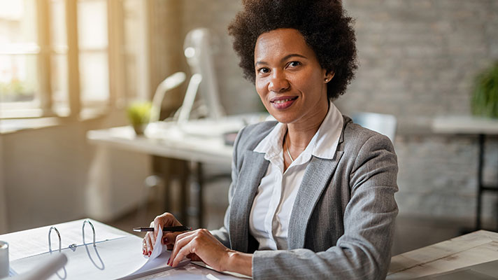 minority female insurance professional doing paper work
