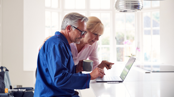 man and woman looking at a laptop screen