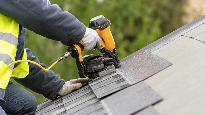 close up of person working on roof