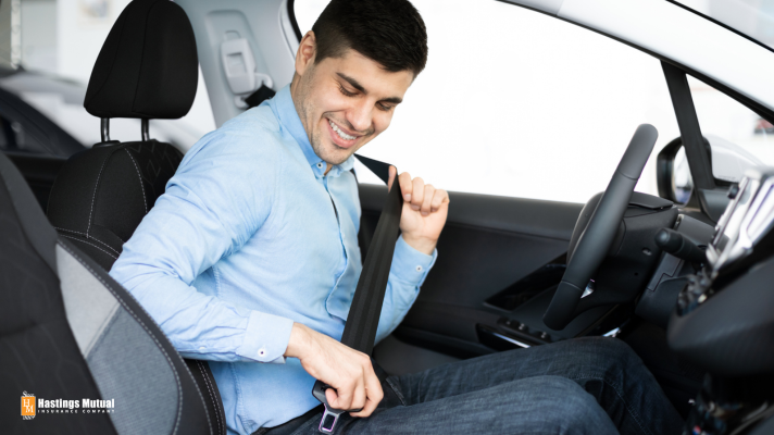 young driver putting on seat belt