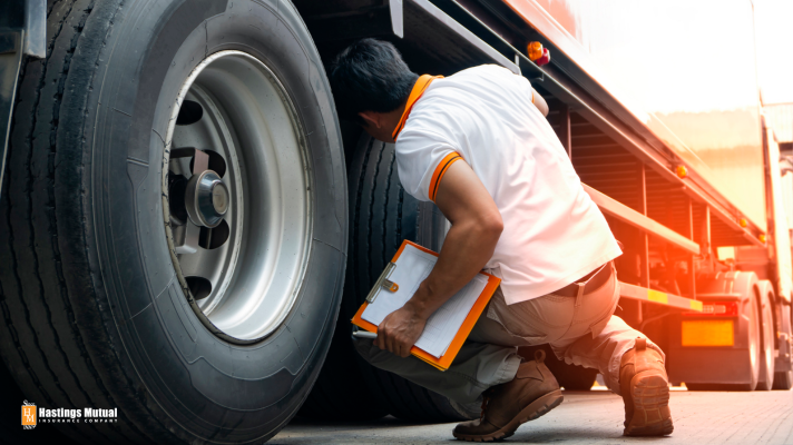 man inspecting tractor trailer