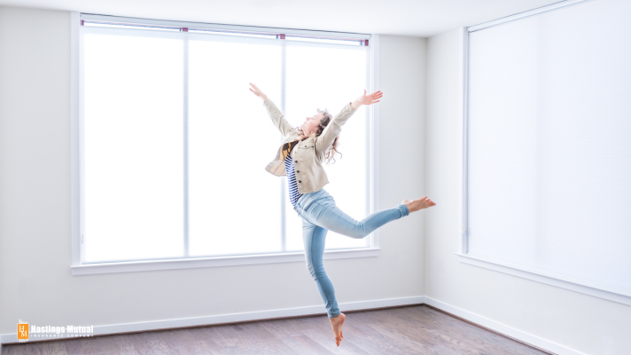 woman dancing in empty apartment