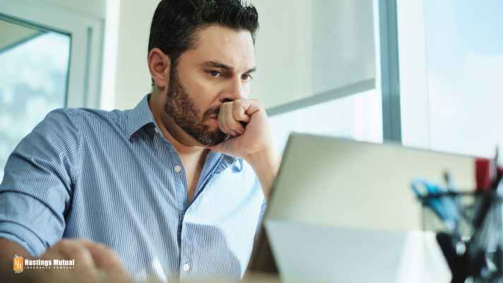 nervous man looking at a computer screen