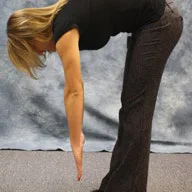 person standing, bending at the waist, and touching their toes
