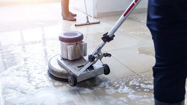 close up of custodians cleaning a floor