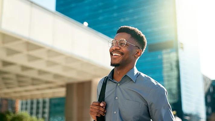 worker smiling as he's walking into work"