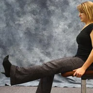 person sitting and extenting left leg straight in front of them